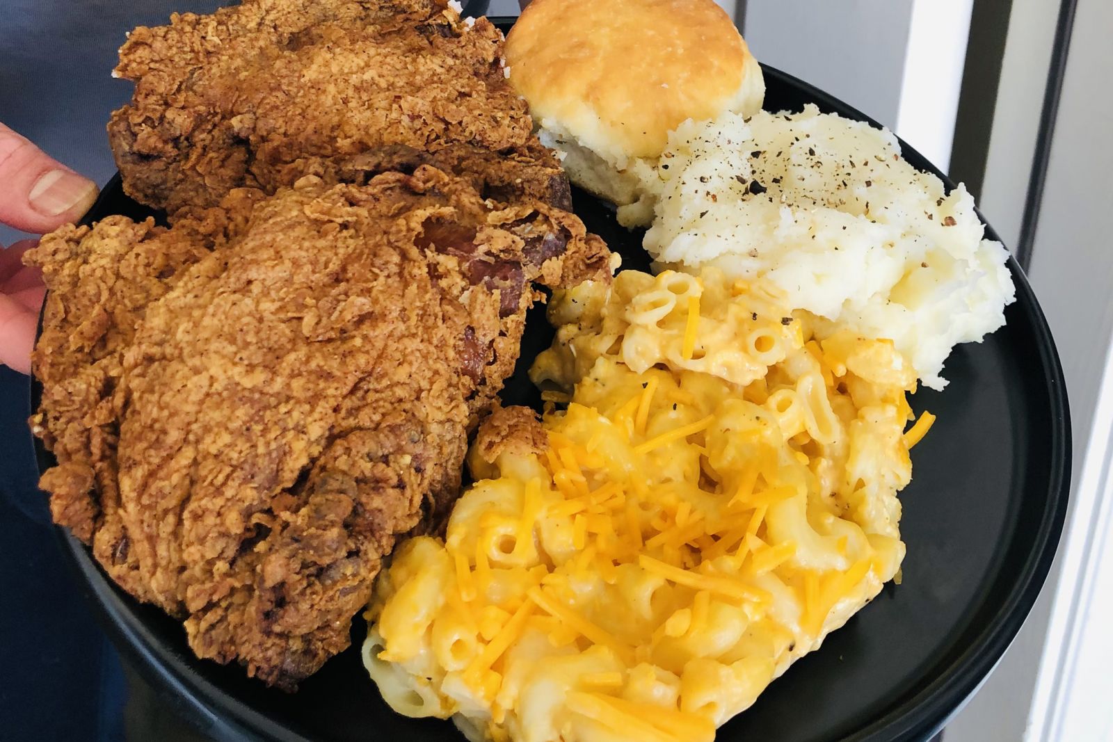Showing off one of our Fried Chicken Plates with two sides and a roll
